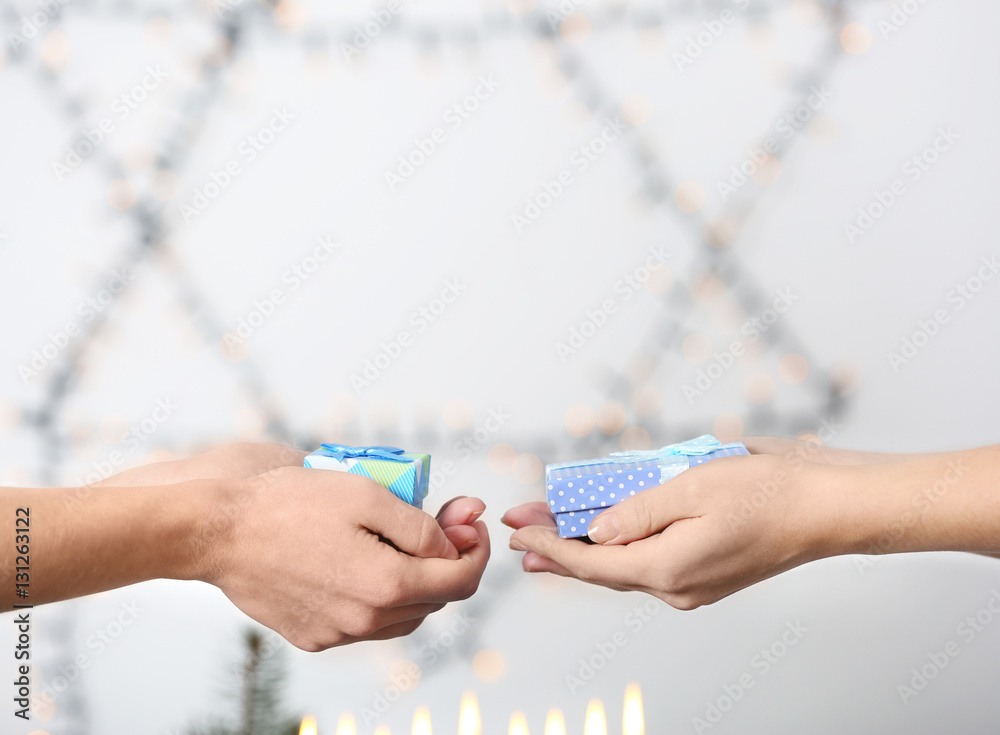 People giving presents for Hanukkah to each other, closeup People giving presents for Hanukkah to each other, closeup