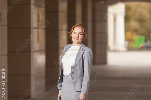 Red haired business women in grey suit © logdog7