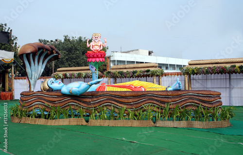 Idol of Indian Hindu God Visnu slleping on sesha panpu or serpent and bramha photo