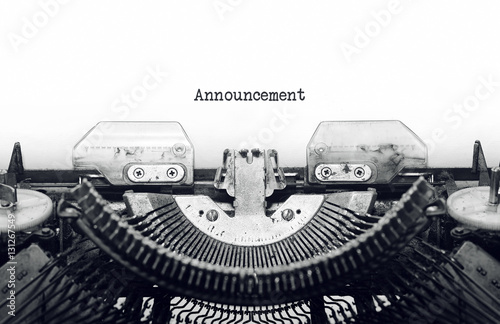 Vintage typewriter on white background with text Announcement.
