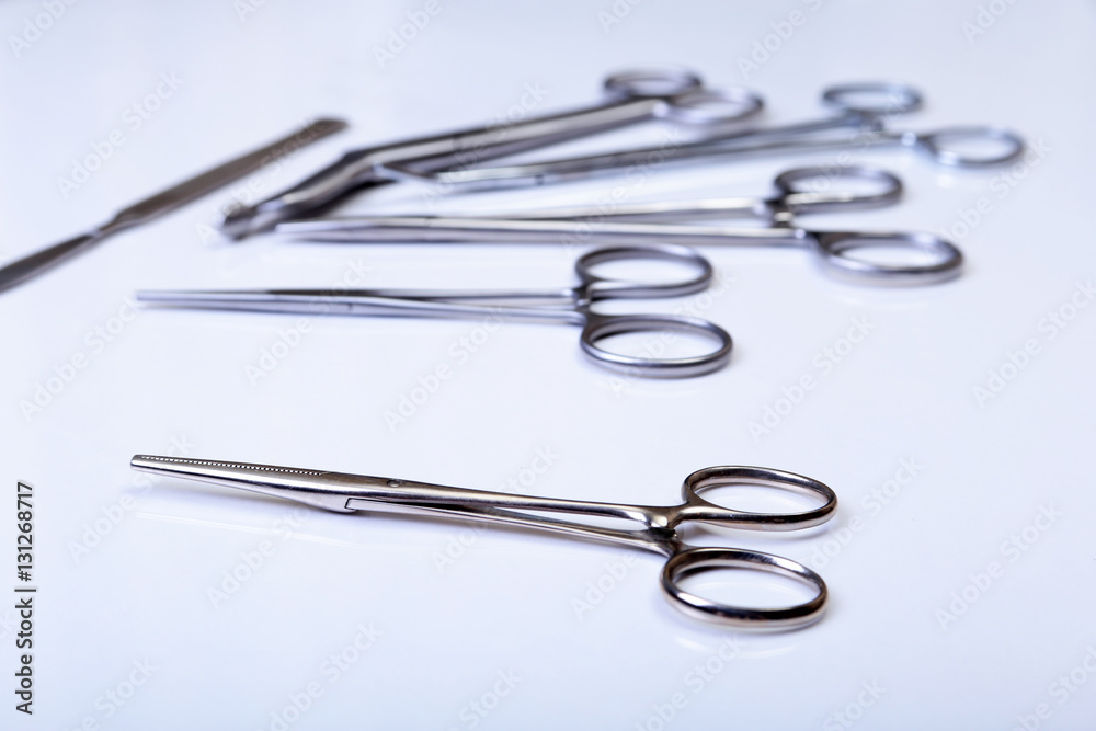 surgical instruments and tools including scalpels, forceps tweezers arranged on a table for surgery surgical instruments and tools including scalpels, forceps tweezers arranged on a table for surgery