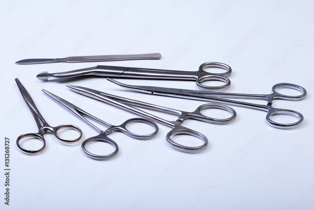 surgical instruments and tools including scalpels, forceps tweezers arranged on a table for surgery surgical instruments and tools including scalpels, forceps tweezers arranged on a table for surgery