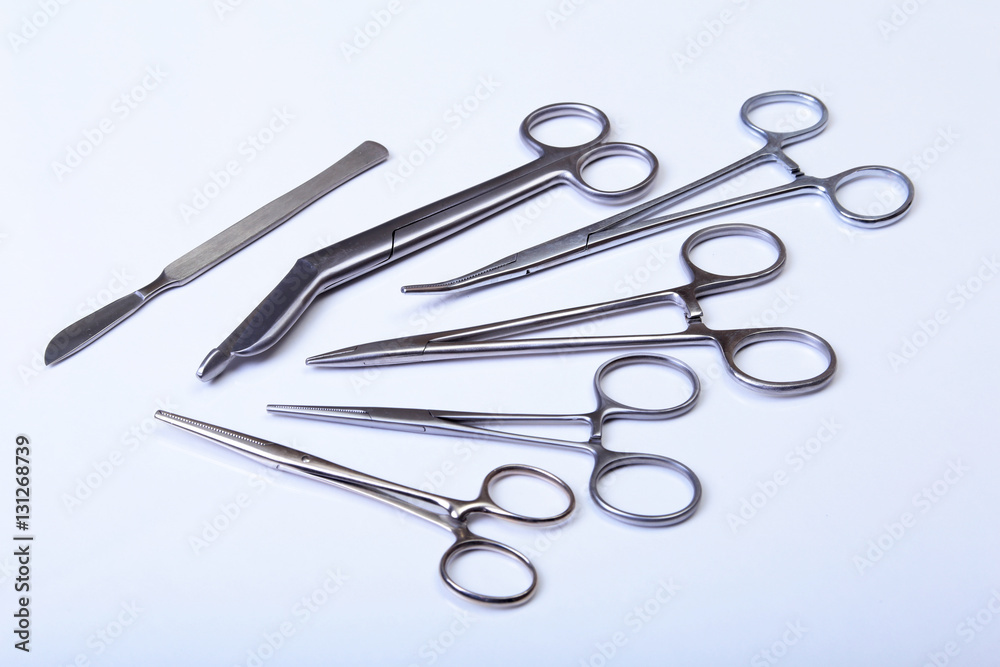 surgical instruments and tools including scalpels, forceps tweezers arranged on a table for surgery surgical instruments and tools including scalpels, forceps tweezers arranged on a table for surgery