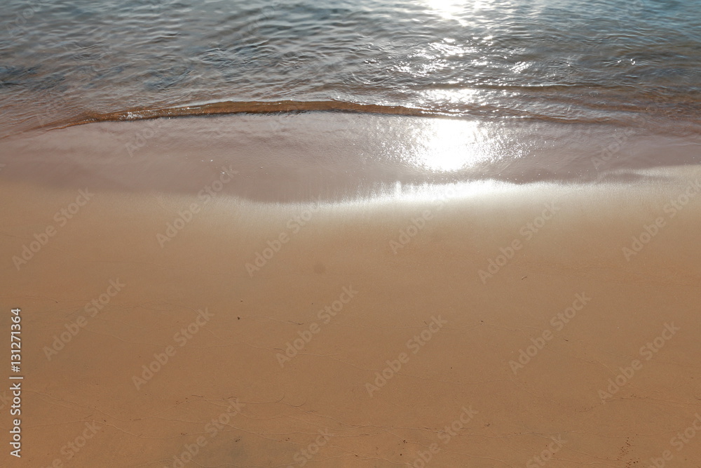 Soft wave of blue ocean on sandy beach. Background.