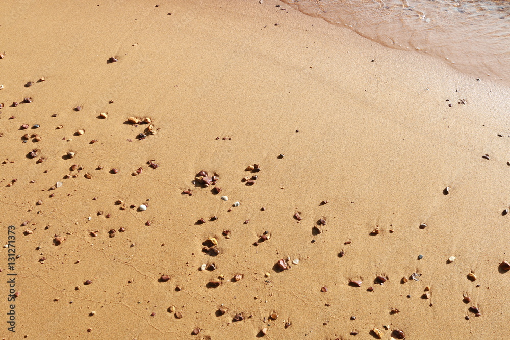 Fototapeta premium Soft wave of blue ocean on sandy beach. Background.