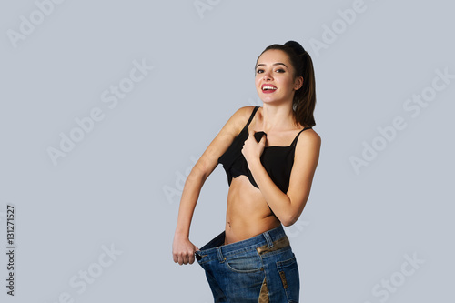 beautiful young woman with big jeans weight loss