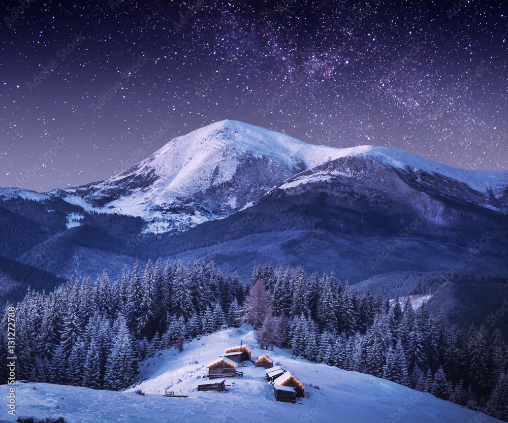 Naklejka premium Mountain village in light of rising moon