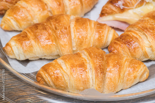 fresh croissants on wooden table 