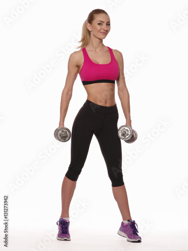 Sexy athletic young woman with perfect fitness body wearing the sport clothes is posing on the white isolated background, diet and healthy lifestyle, studio shoot