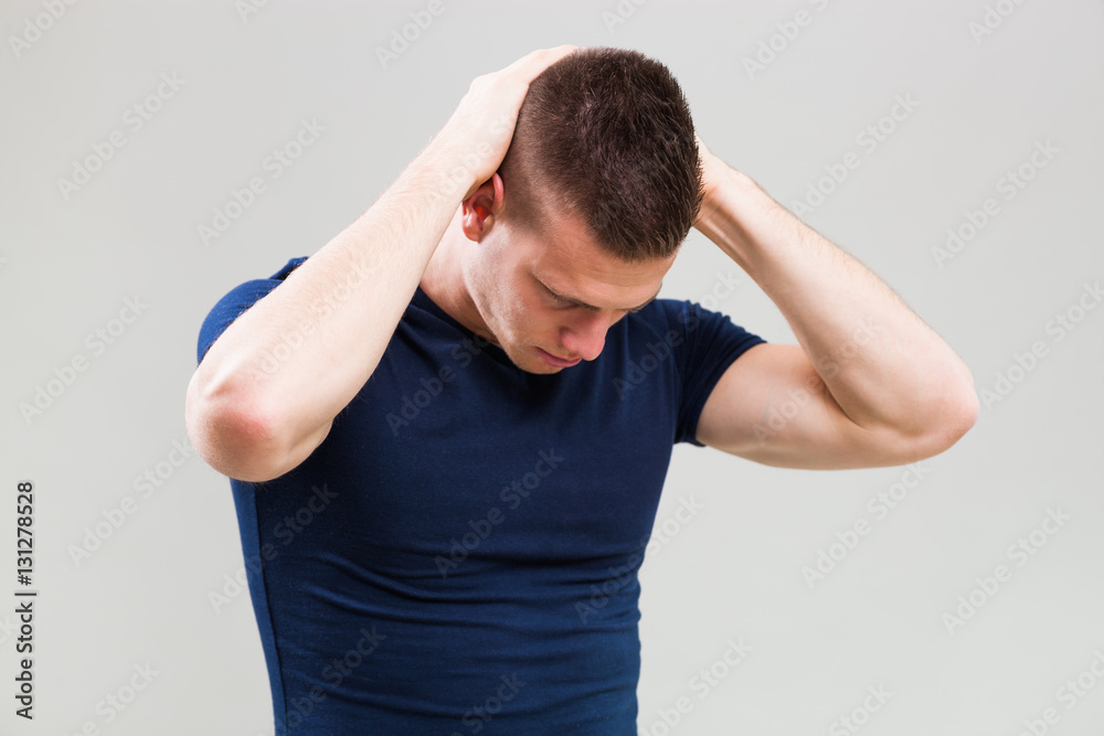 Studio shot image of young man who is stretching his body. Studio shot image of young man who is stretching his body.