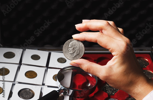 Woman looks at the Dollar coin