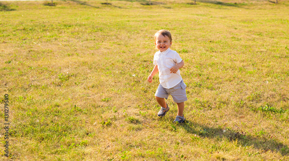 Baby boy laughs on a sunny day Baby boy laughs on a sunny day
