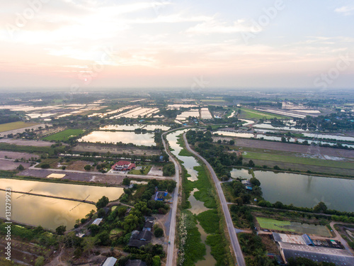 Aerial view of Rice farm with Water at Sunset.