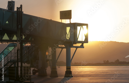 aerobridge in plane parked in sunset photo