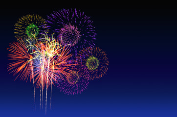 Beautiful colorful fireworks burst in the dark sky, long exposure shot of pyrotechnics. Fireworks celebration and the city night light background.