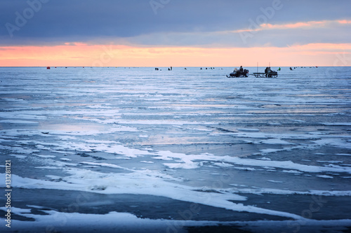 Dawn on the frozen Baltic Sea Biosphere polygon. Ice fishing for photo