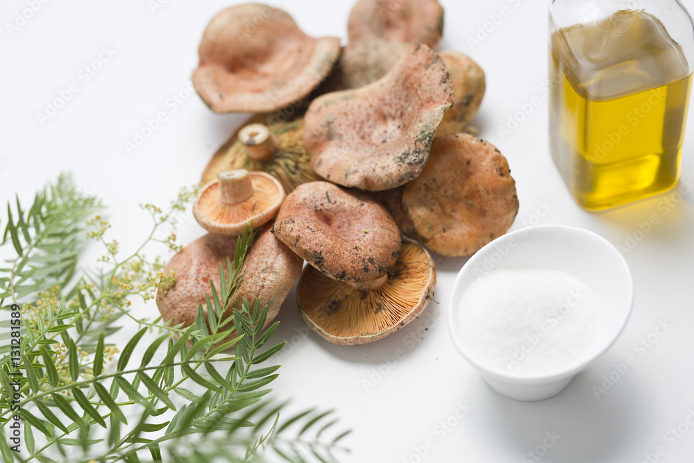 Mushrooms stacked on a white background, with decoration next to it. Mushrooms stacked on a white background, with decoration next to it.