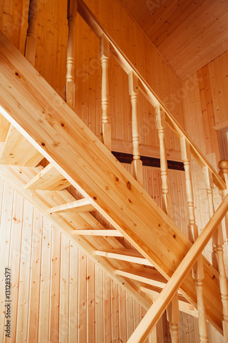 staircase and banisters inside of wooden house