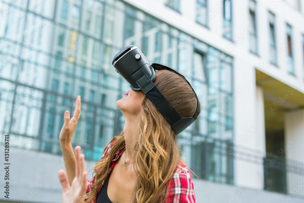 Young woman using high tech virtual reality glasses outdoor Young woman using high tech virtual reality glasses outdoor