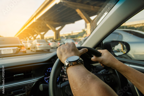 Closeup left hand driving on traffic jam background, Business Co