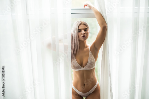 Sexy blonde girl near window and possing © dianagrytsku