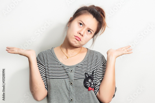 Fotografia Portrait asia young woman arms out shrugs shoulders who cares so what I don't know isolated white wall background