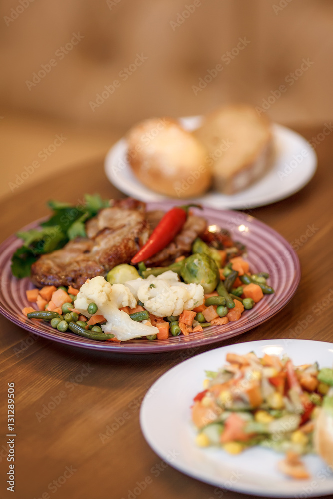 Grilled steak with vegetables and herbs on plate