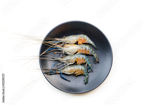Close up fresh shrimp with eggs on black dish isolated on white background