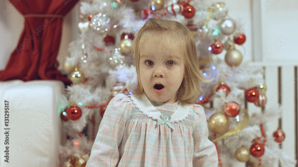 Cute little girl near the Christmas tree Cute little girl near the Christmas tree