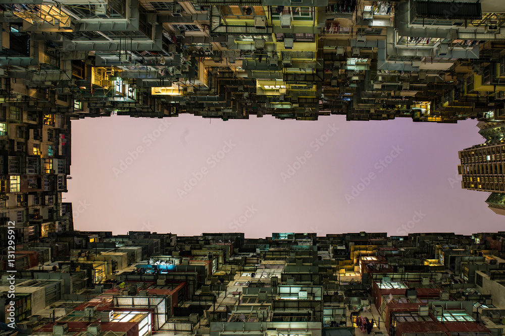 Hong Kong, China skyline panorama from across Victoria Harbor. Hong Kong city skyline view from harbor with skyscrapers buildings reflect in water at sunset