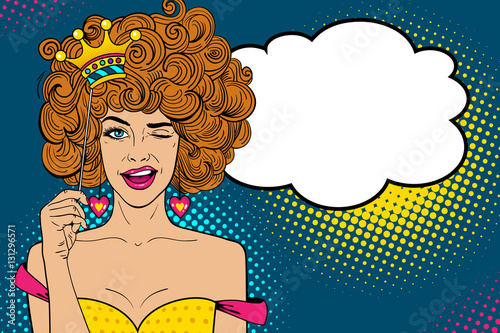 Pop art face. Young sexy ginger woman holding funny paper crown on stick, smiling and winking and empty speech bubble. Vector illustration in retro comic style. Holiday party invitation poster.