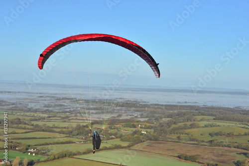 A Paraglider on a cold misty morning in December at Devils Dyke in Brighton, West Sussex. 