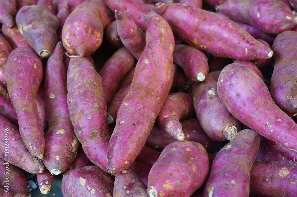 Japanese red sweet potatoes (yams) in bulk at the farmers market Japanese red sweet potatoes (yams) in bulk at the farmers market