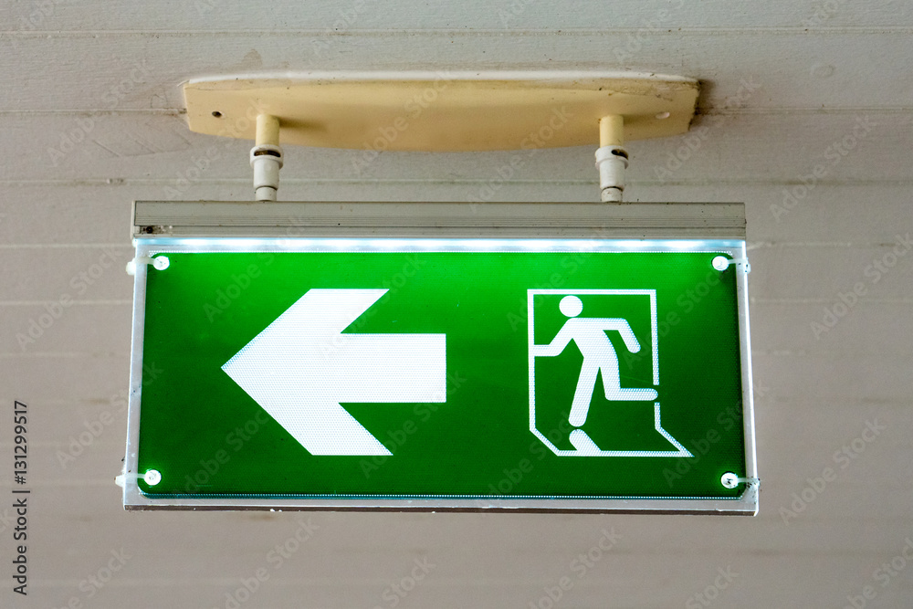 old Green fire exit sign at hotel. old Green fire exit sign at hotel.