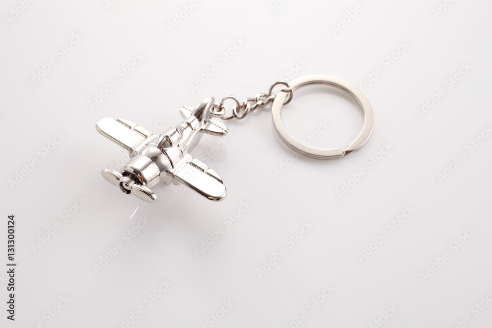silver air plane key chain on the white background silver air plane key chain on the white background