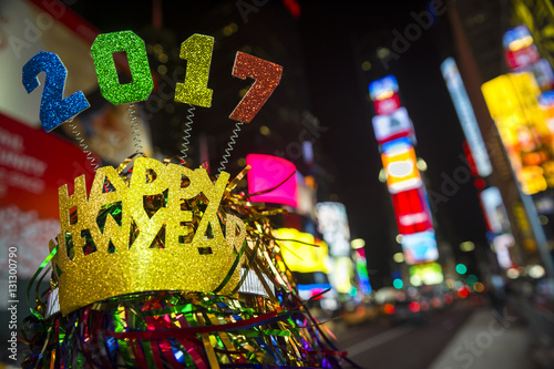 Colorful 2017 Happy New Year message with celebration tinsel flying on novelty party hat in Times Square, New York City