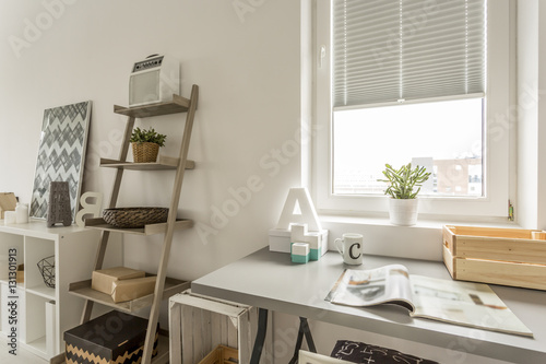 Grey desk and wooden shelf in the living room © Photographee.eu