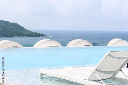 Beach lounge swimming pool with pool bed or Sundeck on Sea view for vacation, Relax vacation time with nice place at sea beach in Thailand