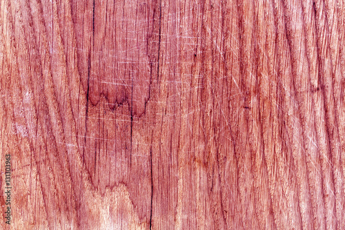 Wooden board surface with scratches.