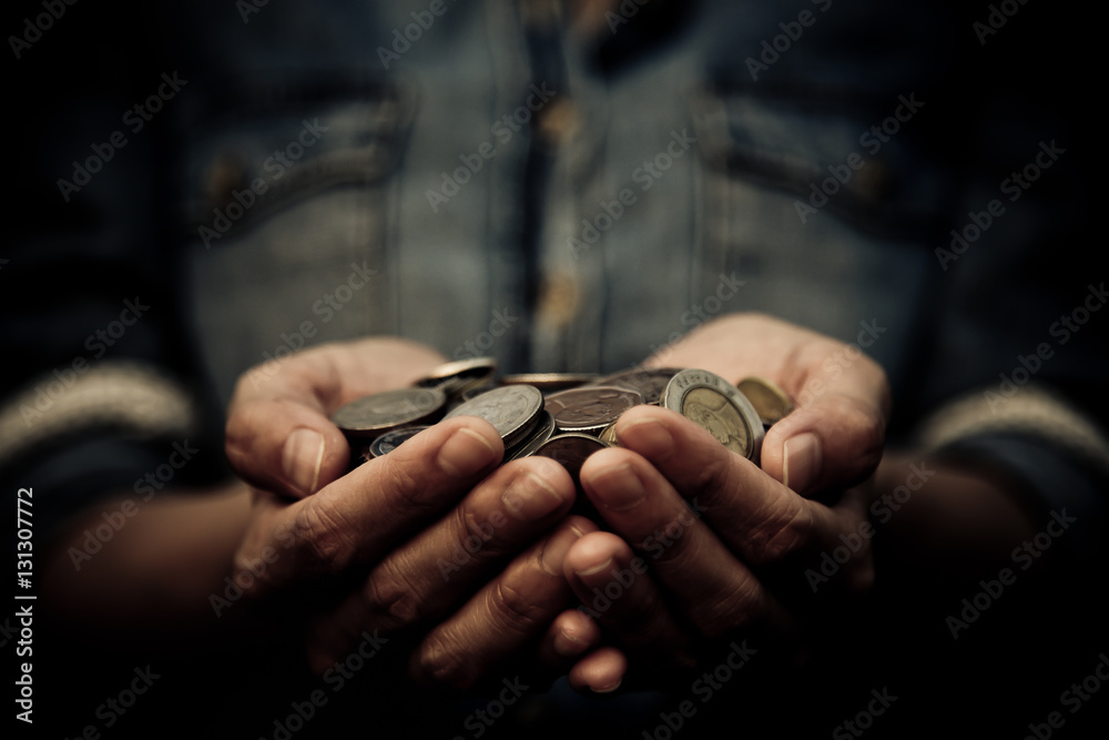 A coins in people hands in saving money concept