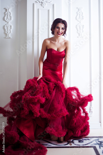 Beauty Brunette model woman in evening red dress. Beautiful fashion luxury makeup and hairstyle, full length