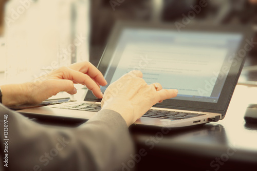Closeup of businesswoman typing on laptop computer.Selective focus