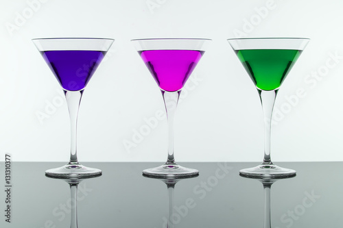 Colorful Cocktails in Martini Glasses Background. Bar Commercials Concept.