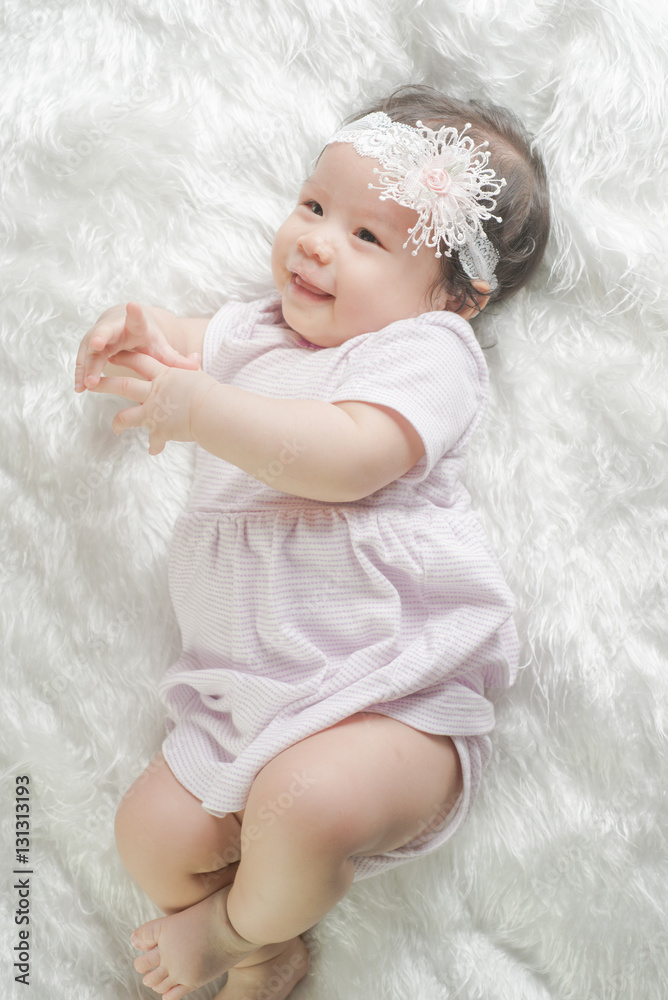 Newborn baby girl posed on blanket of fur Newborn baby girl posed on blanket of fur
