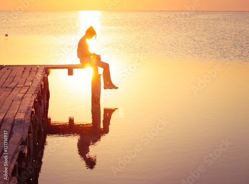 Photography girl reading at the sunset time