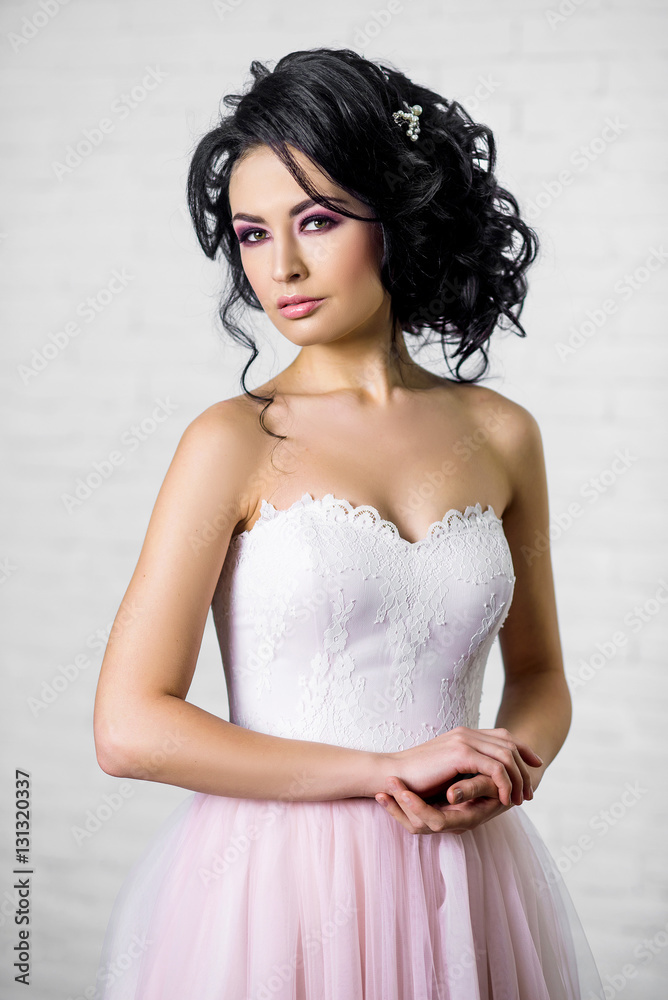 beautiful young brunette woman in a light pink long dress beautiful young brunette woman in a light pink long dress