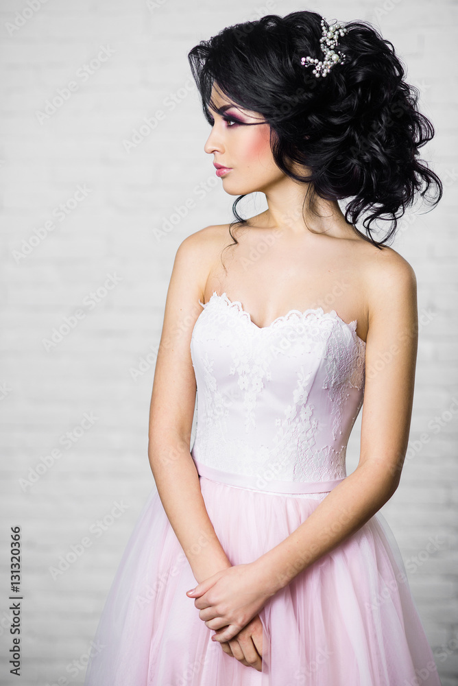 beautiful young brunette woman in a light pink long dress beautiful young brunette woman in a light pink long dress