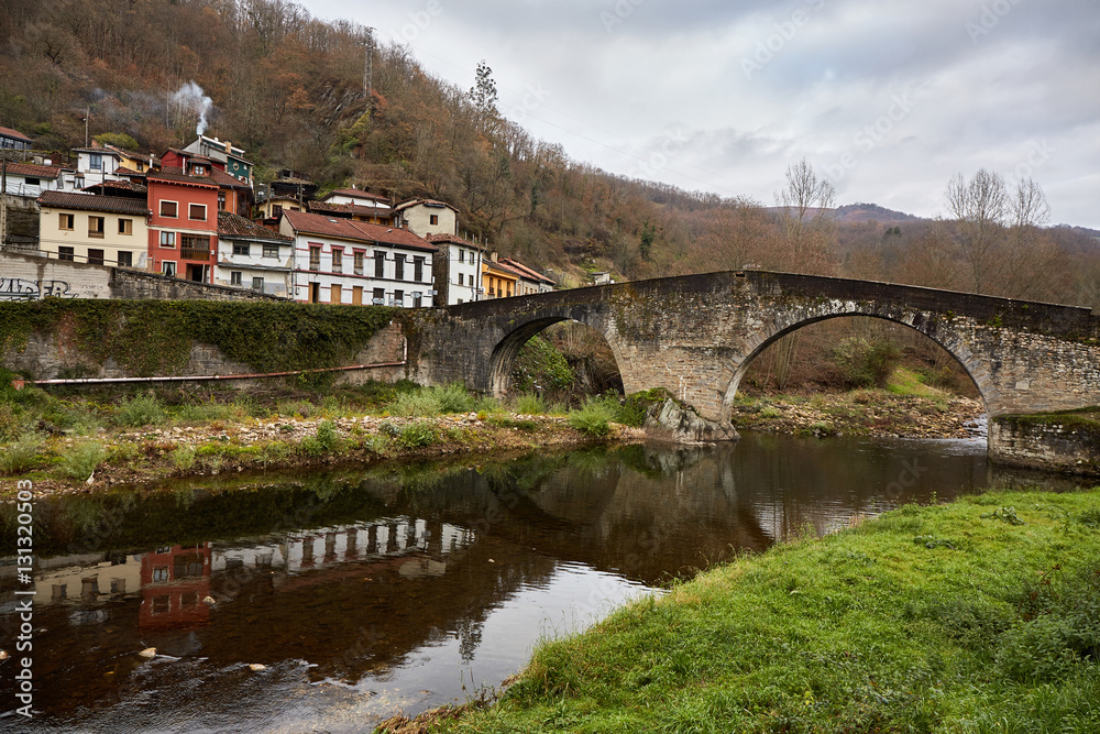 Roman bridge of Puente de Arco. Situated in the village of Puente de Arco, 2 Kilometres from Pola de Laviana, Asturias, Spain. It crosses the Nalon river and its construction date is uncertain.