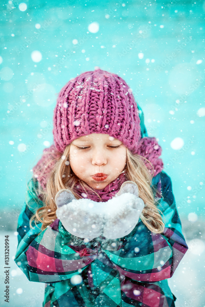Winter portrait of a pretty little girl.