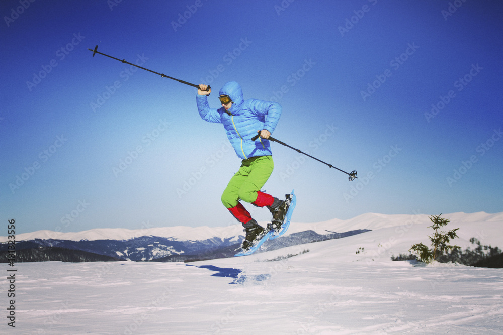 Winter hiking in the mountains on snowshoes with a backpack and Winter hiking in the mountains on snowshoes with a backpack and